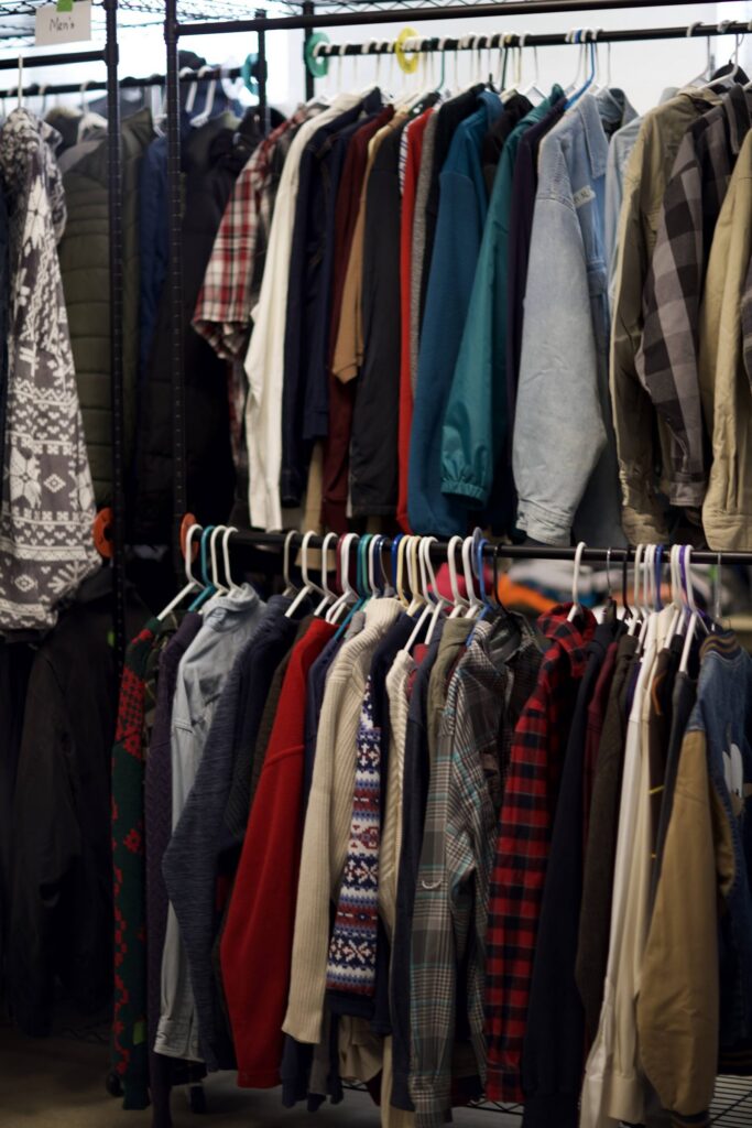 Rack of donated coats, jackets, and flannel shirts in the Outreach on 7th Clothing Closet