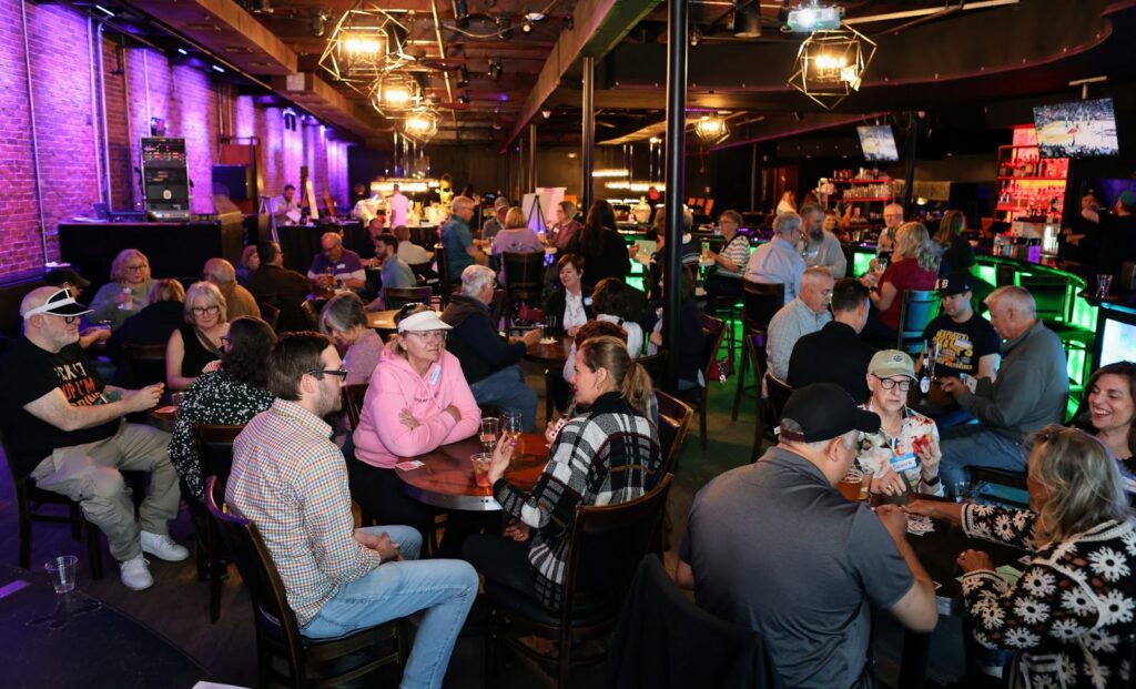 Supporters playing Euchre at card tables during the Outreach on 7th Silent Auction and Euchre Party at 5th Avenue Grill